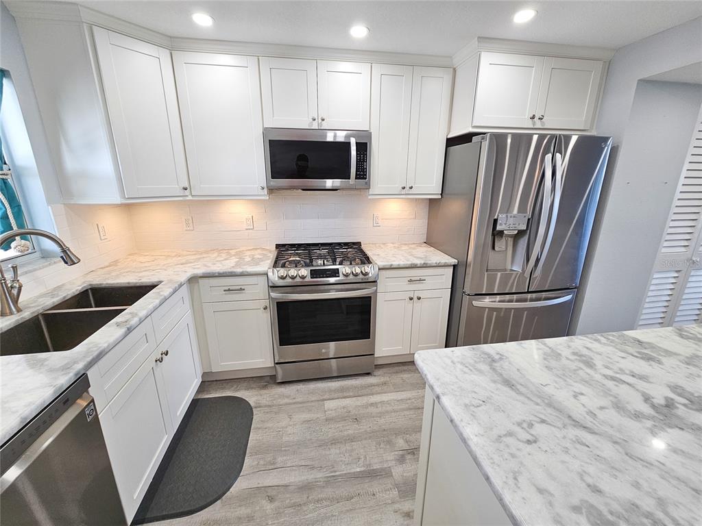 a kitchen with a stove a sink and a refrigerator