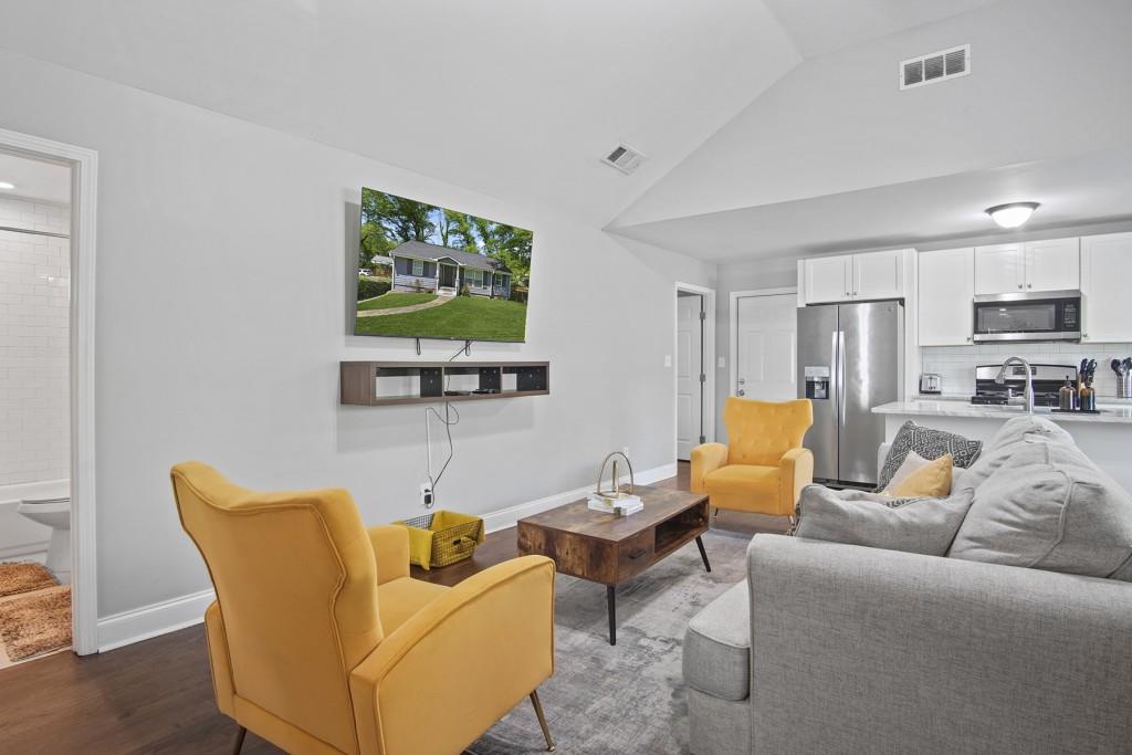 a living room with furniture and a flat screen tv