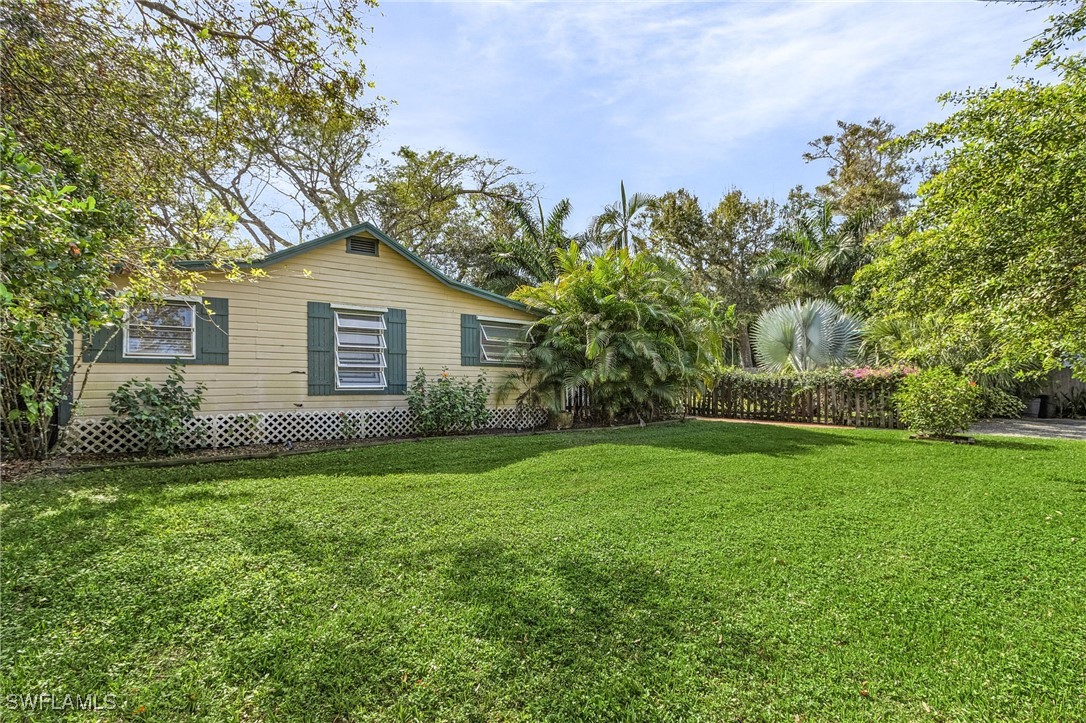 a view of a house with a backyard