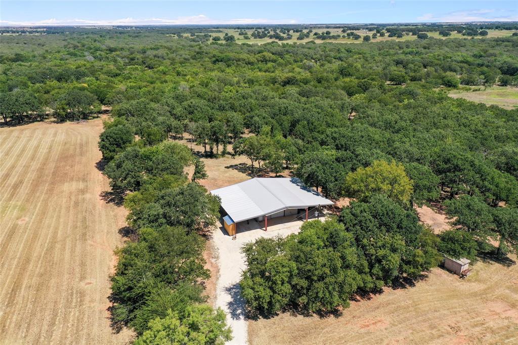 an aerial view of a house with yard