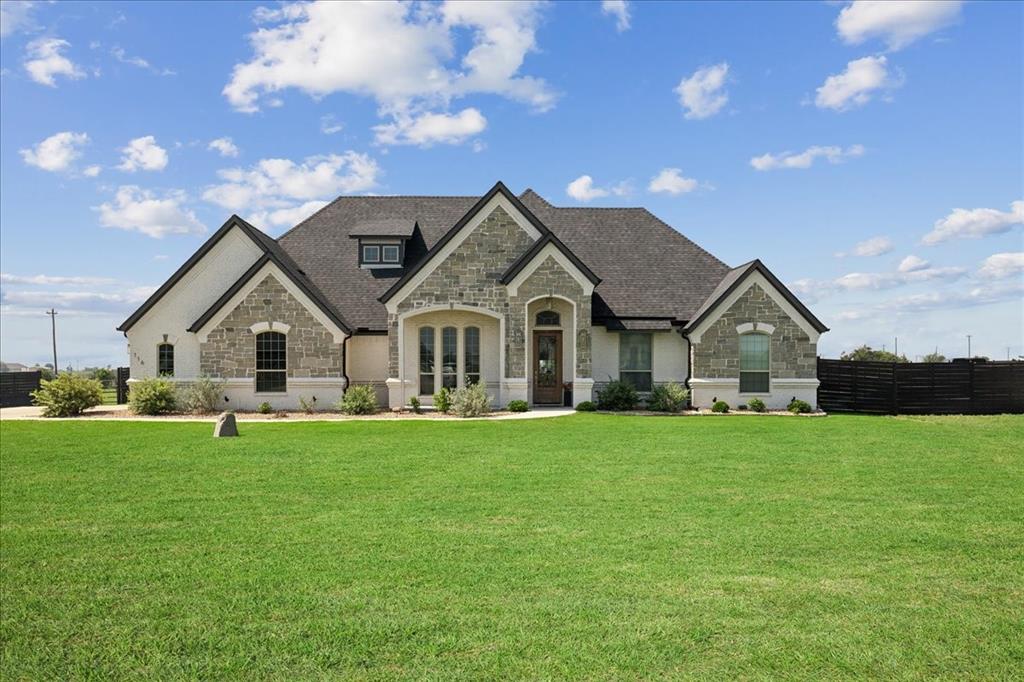 a front view of house with yard and green space