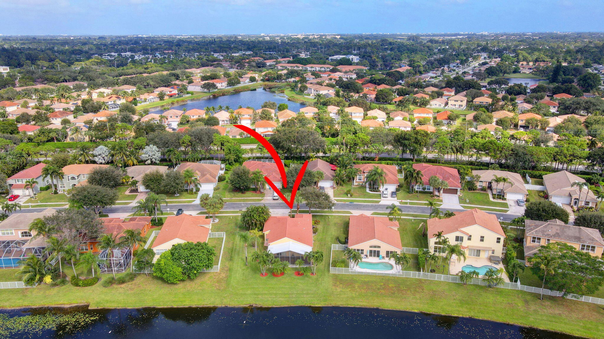 an aerial view of residential houses with outdoor space and swimming pool