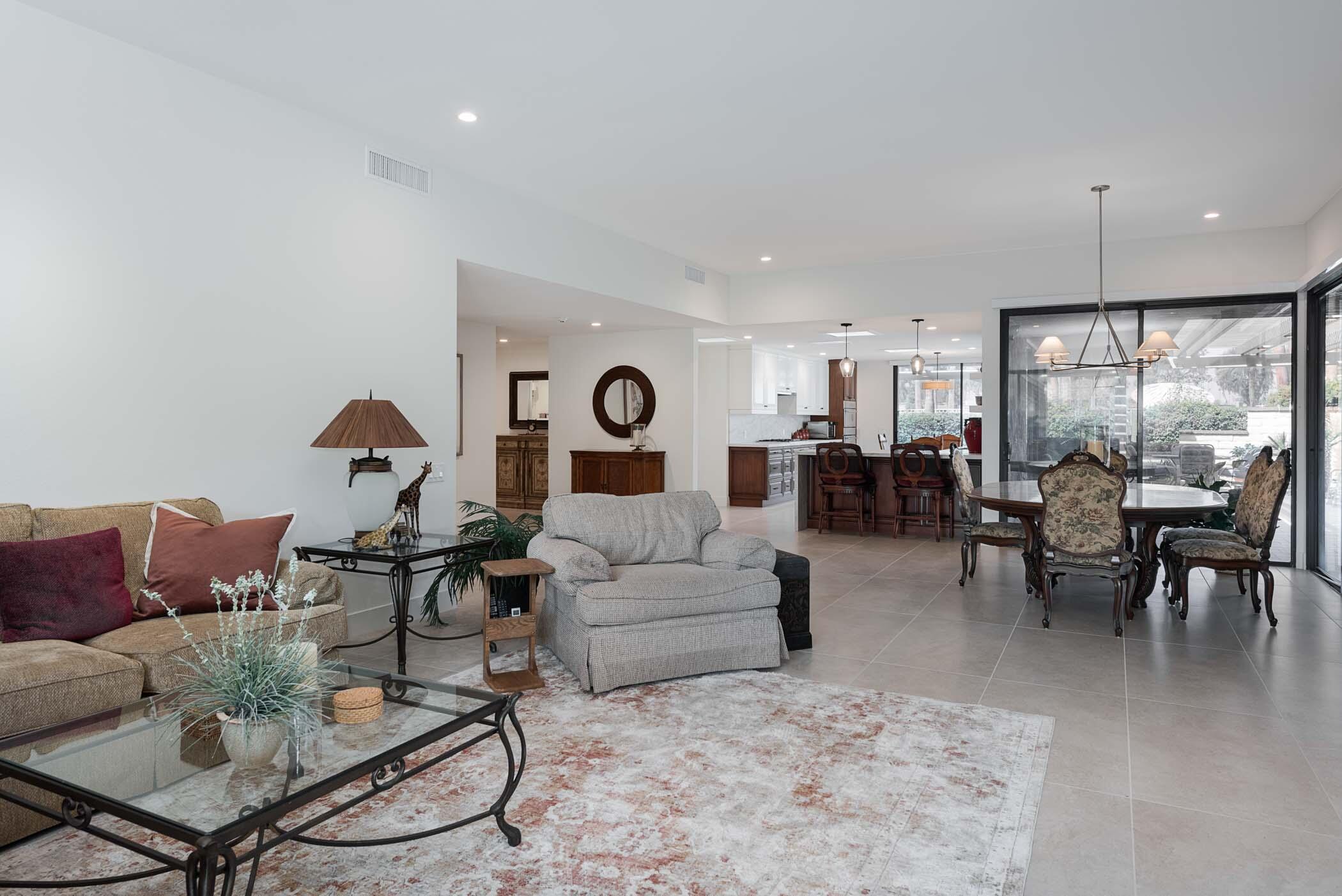 a living room with furniture kitchen view and a dining table