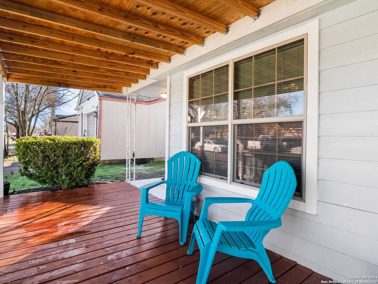 a view of a deck with table and chairs with wooden floor and plants