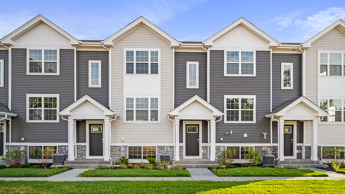 a front view of a house with yard and green space