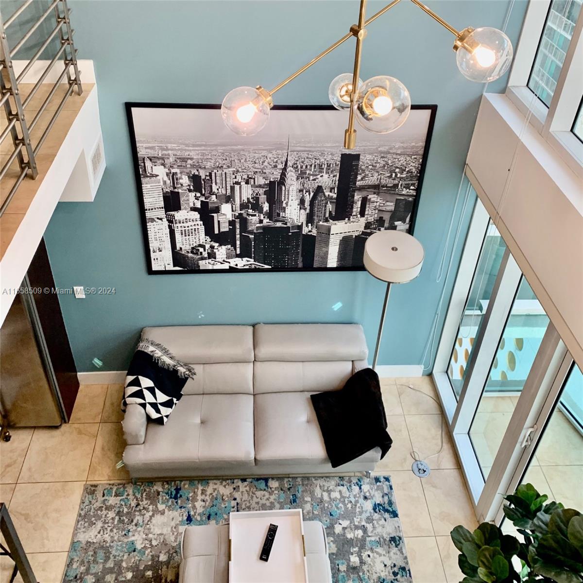 a view of living room with furniture and a chandelier