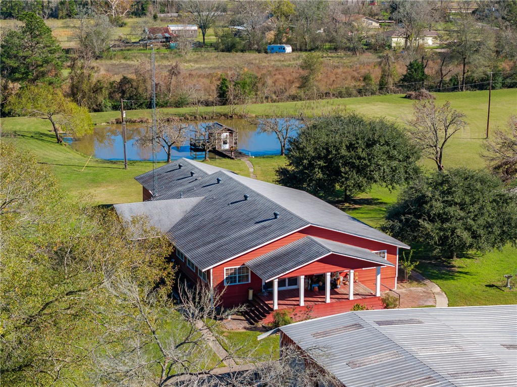 Birds eye view of property with a water view