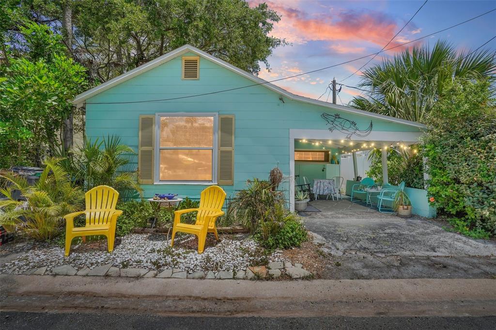 a backyard of a house with table and chairs