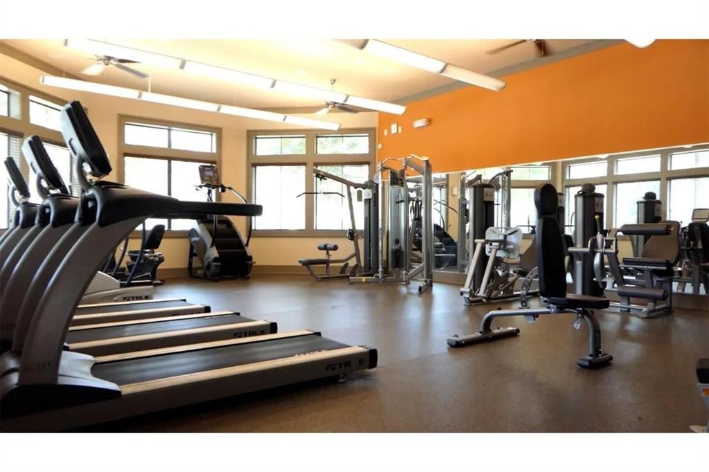 a view of a gym room with gym equipment