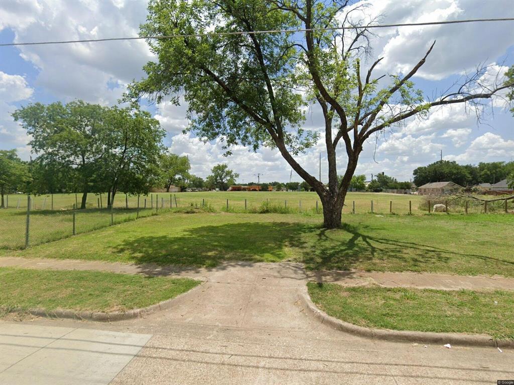 a view of a park with large trees