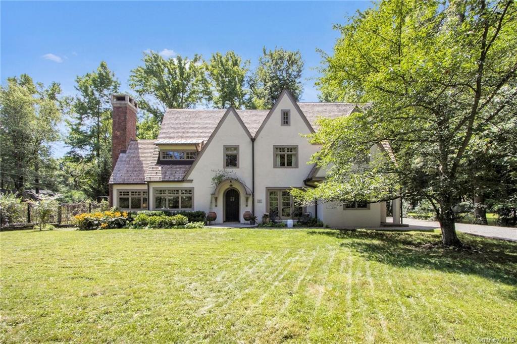 Tudor house featuring a front lawn