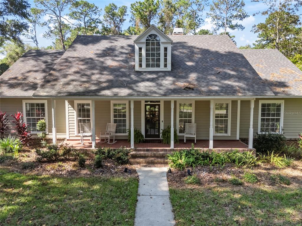 a front view of a house with garden and porch