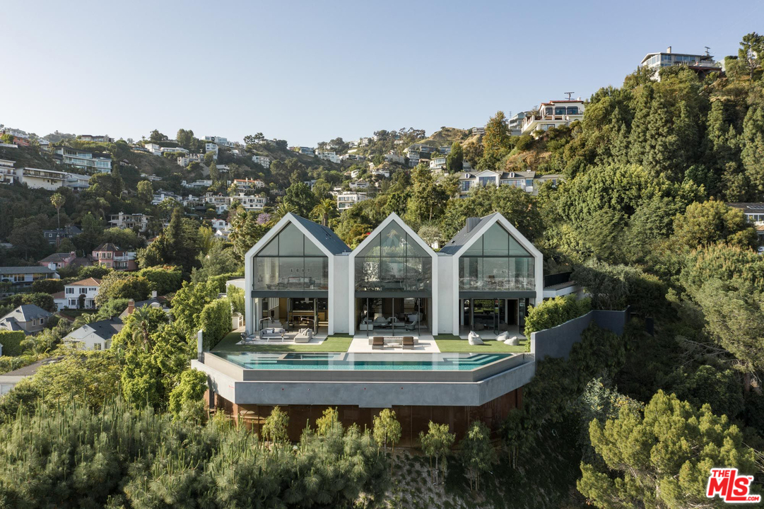 a roof view with sitting space and garden view