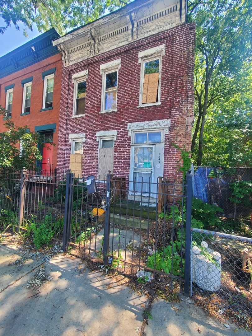 a view of a brick building next to a yard