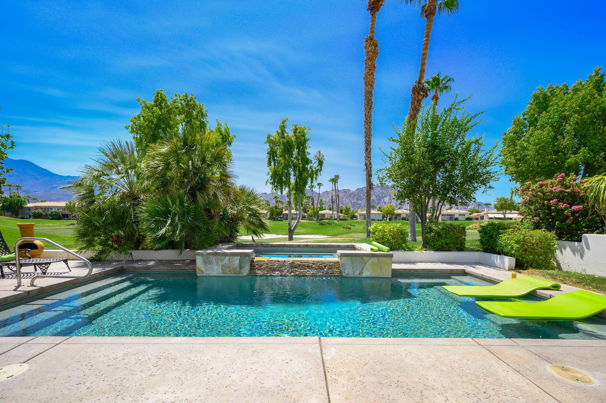 a view of yard with swimming pool and green space