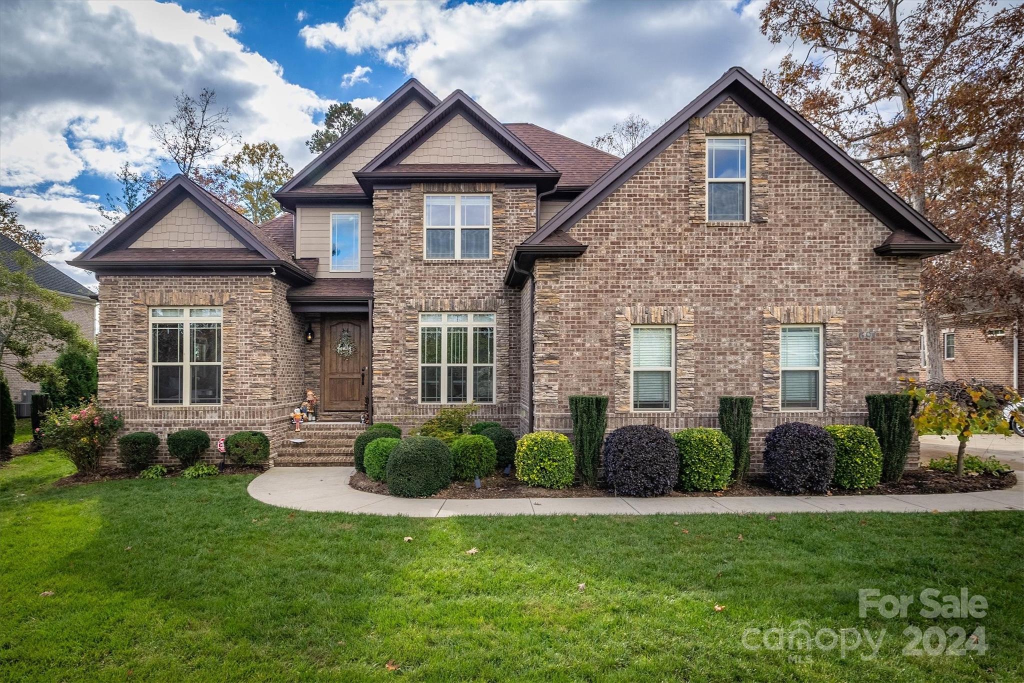 a front view of a house with garden