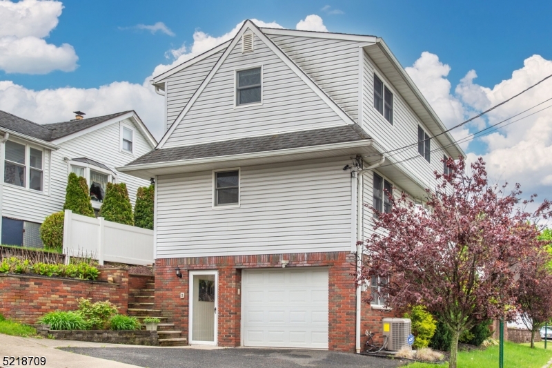 a view of a house with a yard and garage