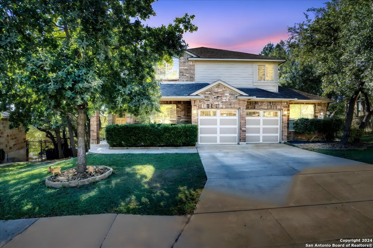 a front view of a house with a yard garage and outdoor seating