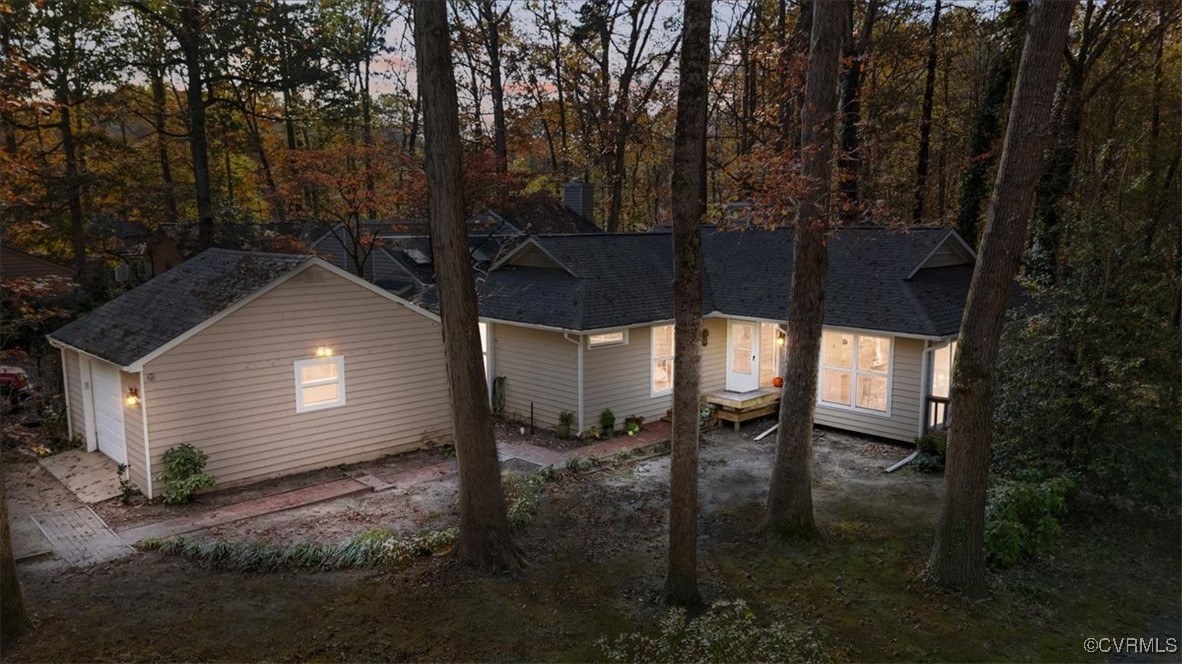 a backyard of a house with table and chairs