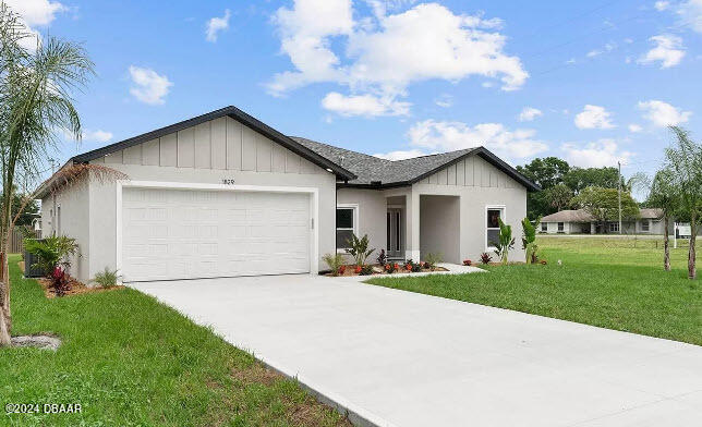 a front view of house with yard and green space