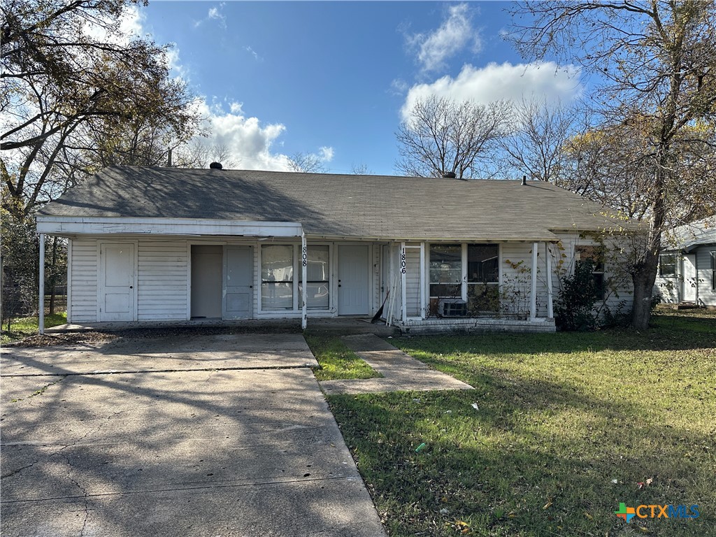 a view of a house with a yard and garage