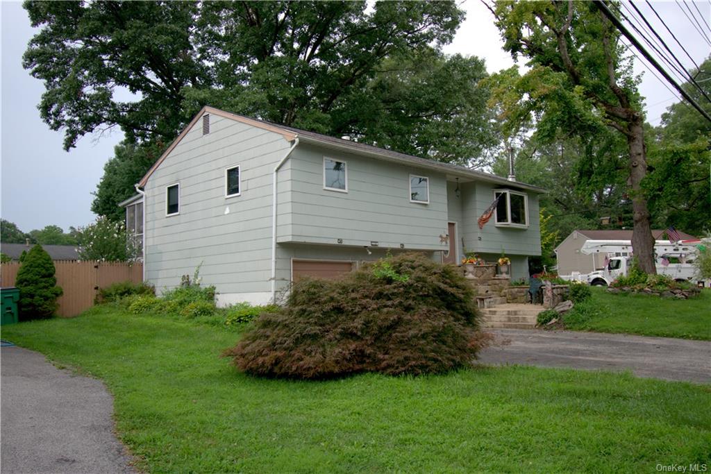 View of front of home featuring a garage and a front lawn