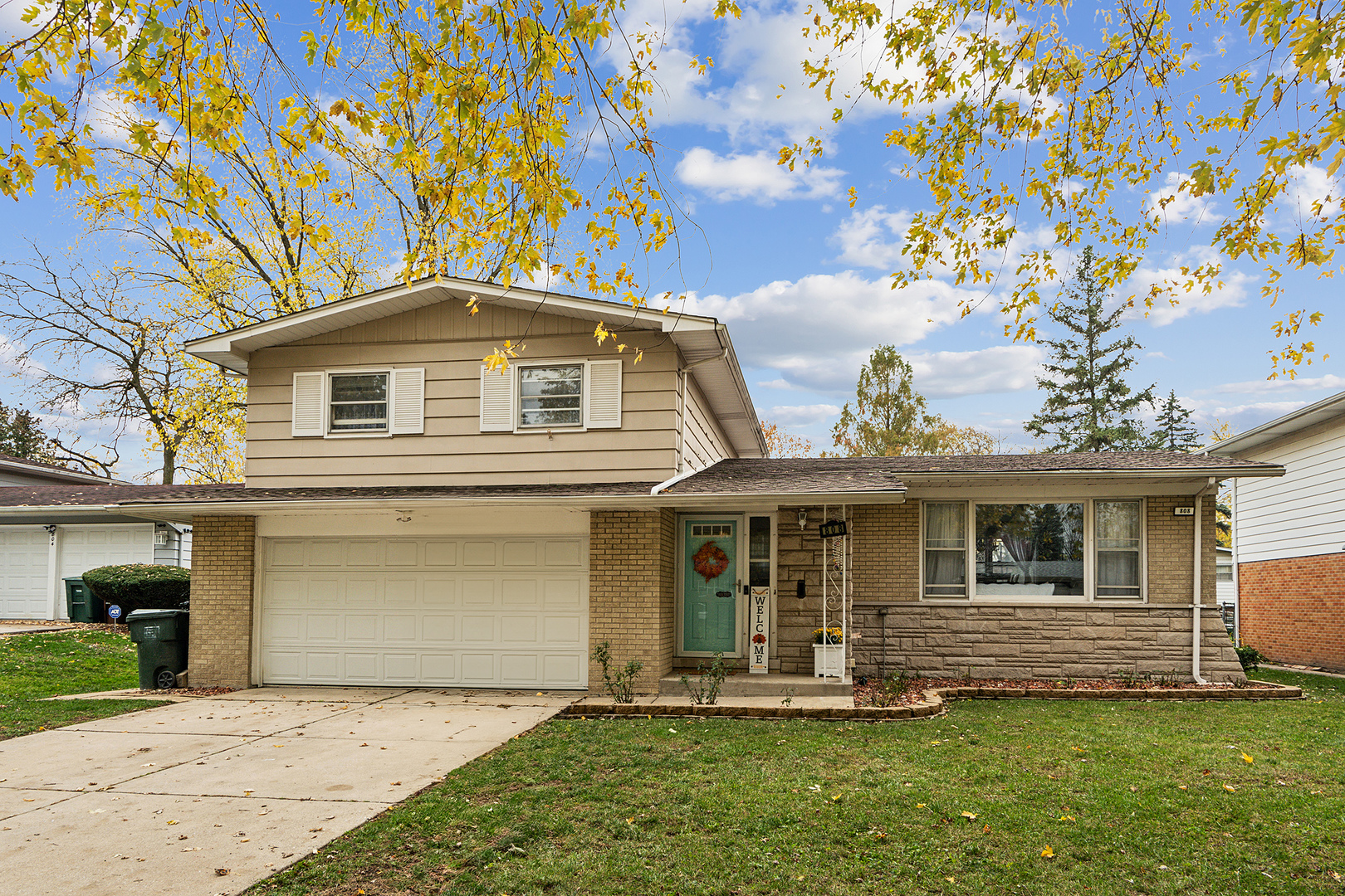 a front view of a house with a yard and garage