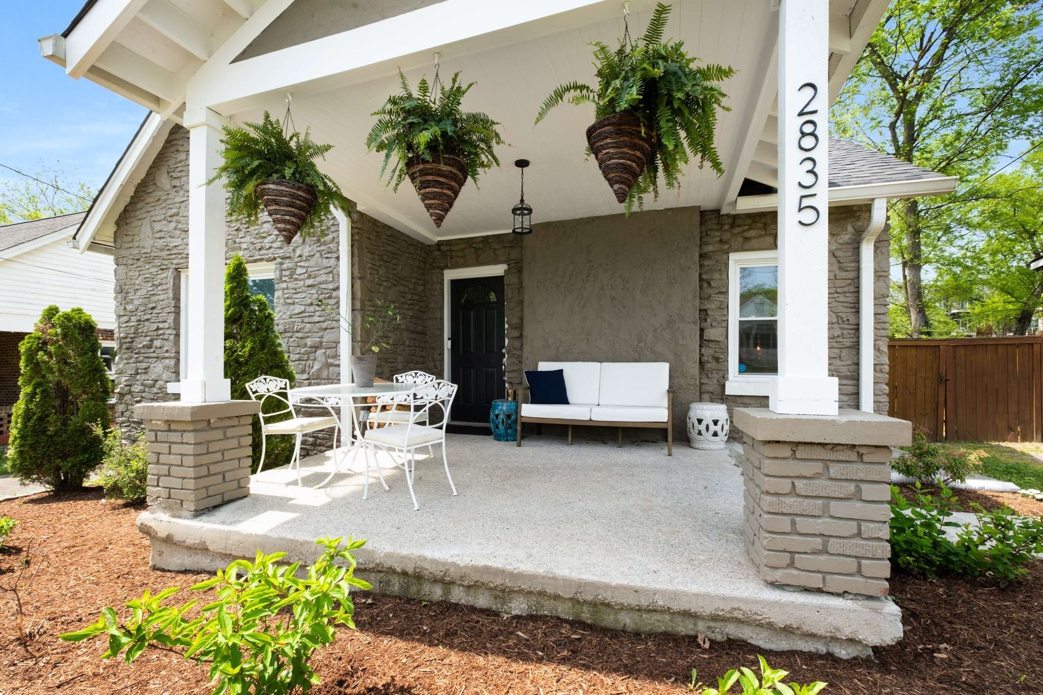 a view of a patio with table and chairs and potted plants