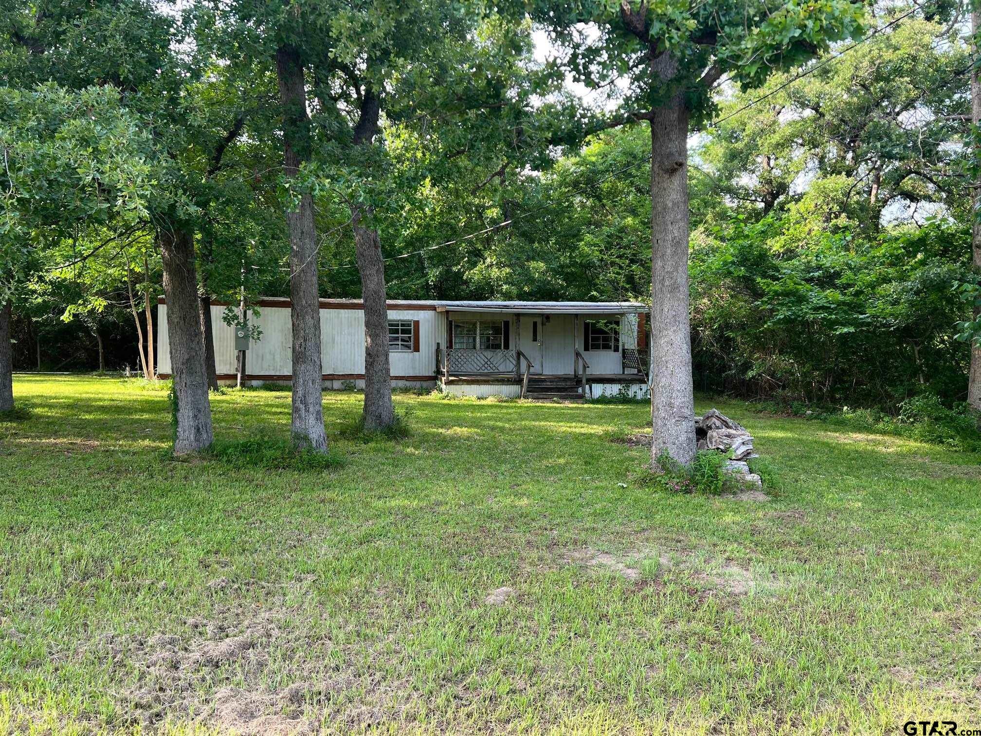 a view of a house with a backyard