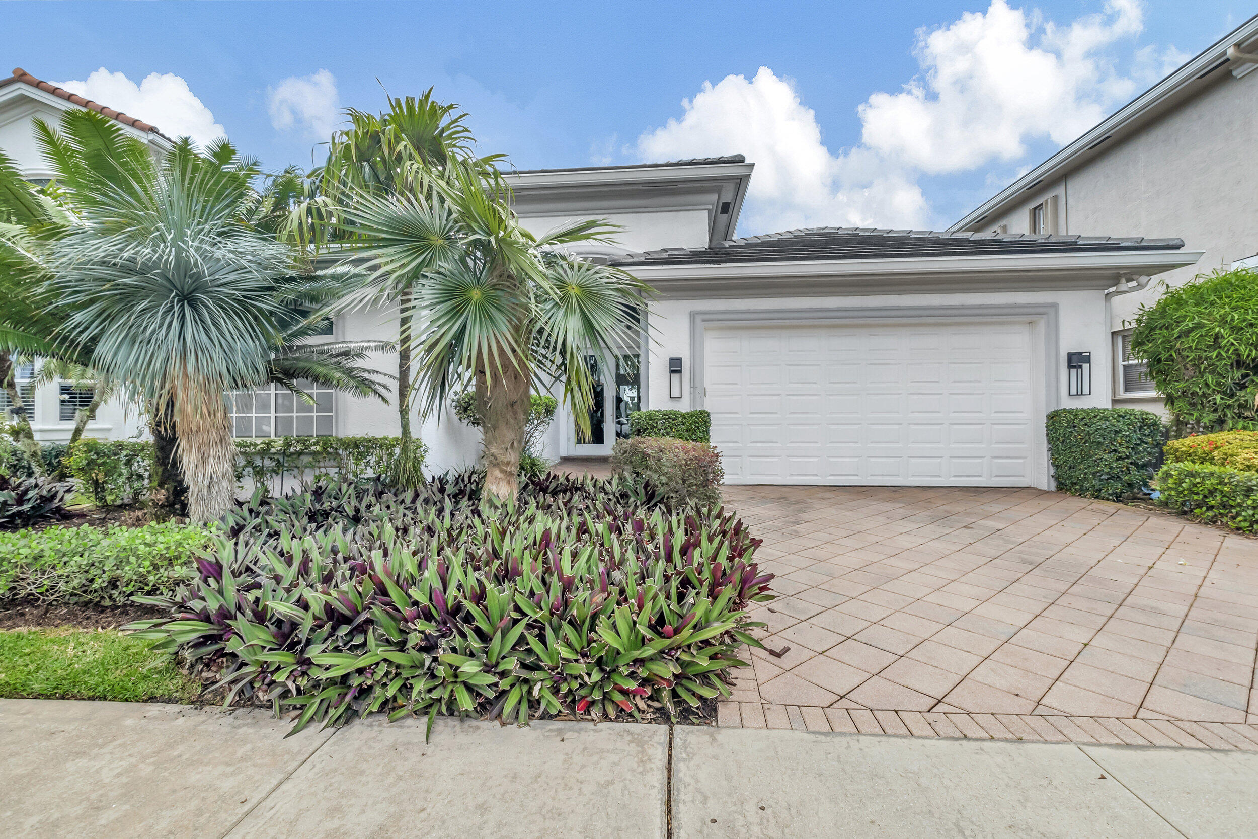 a front view of a house with a garden