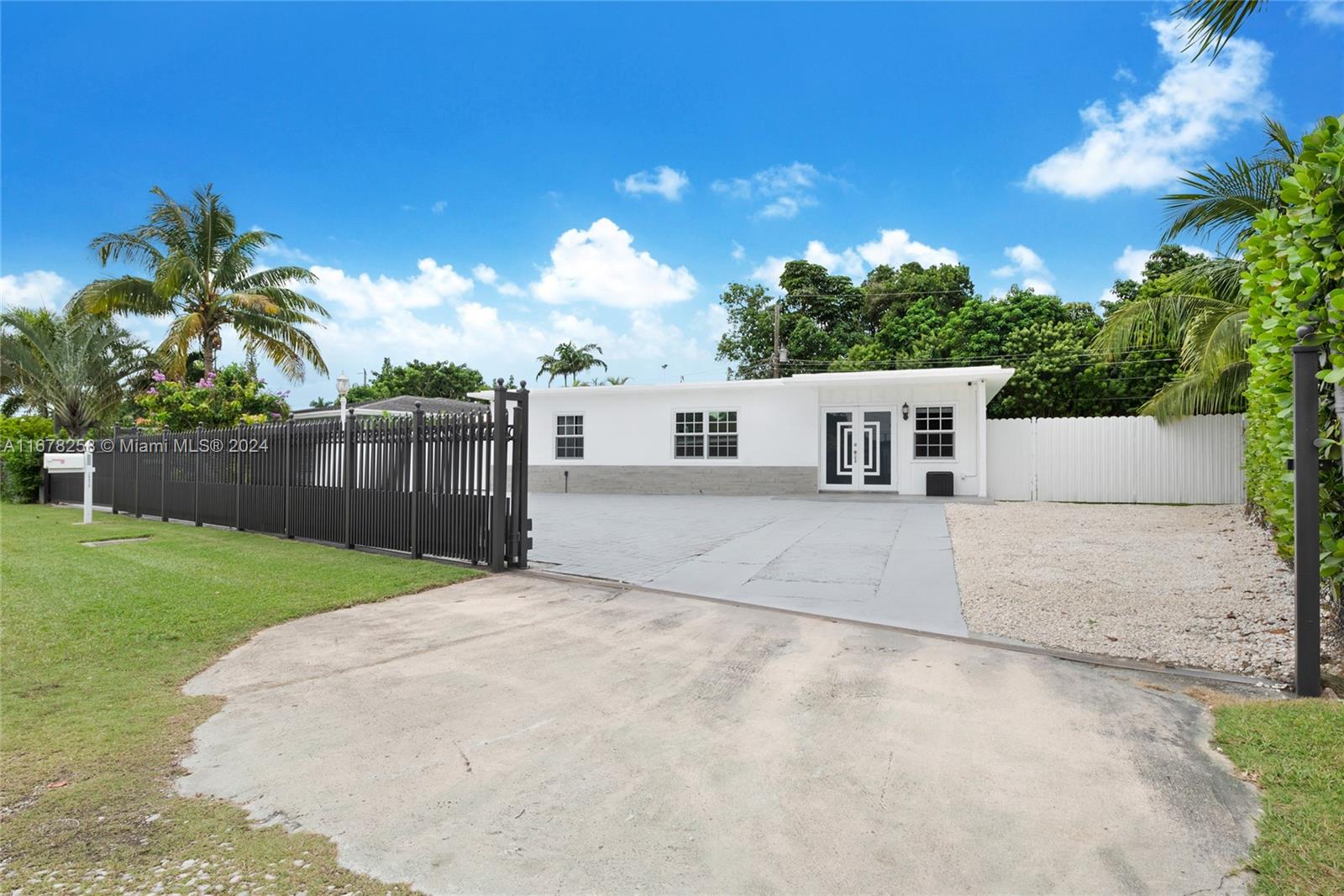 a view of a house with a yard and a garage