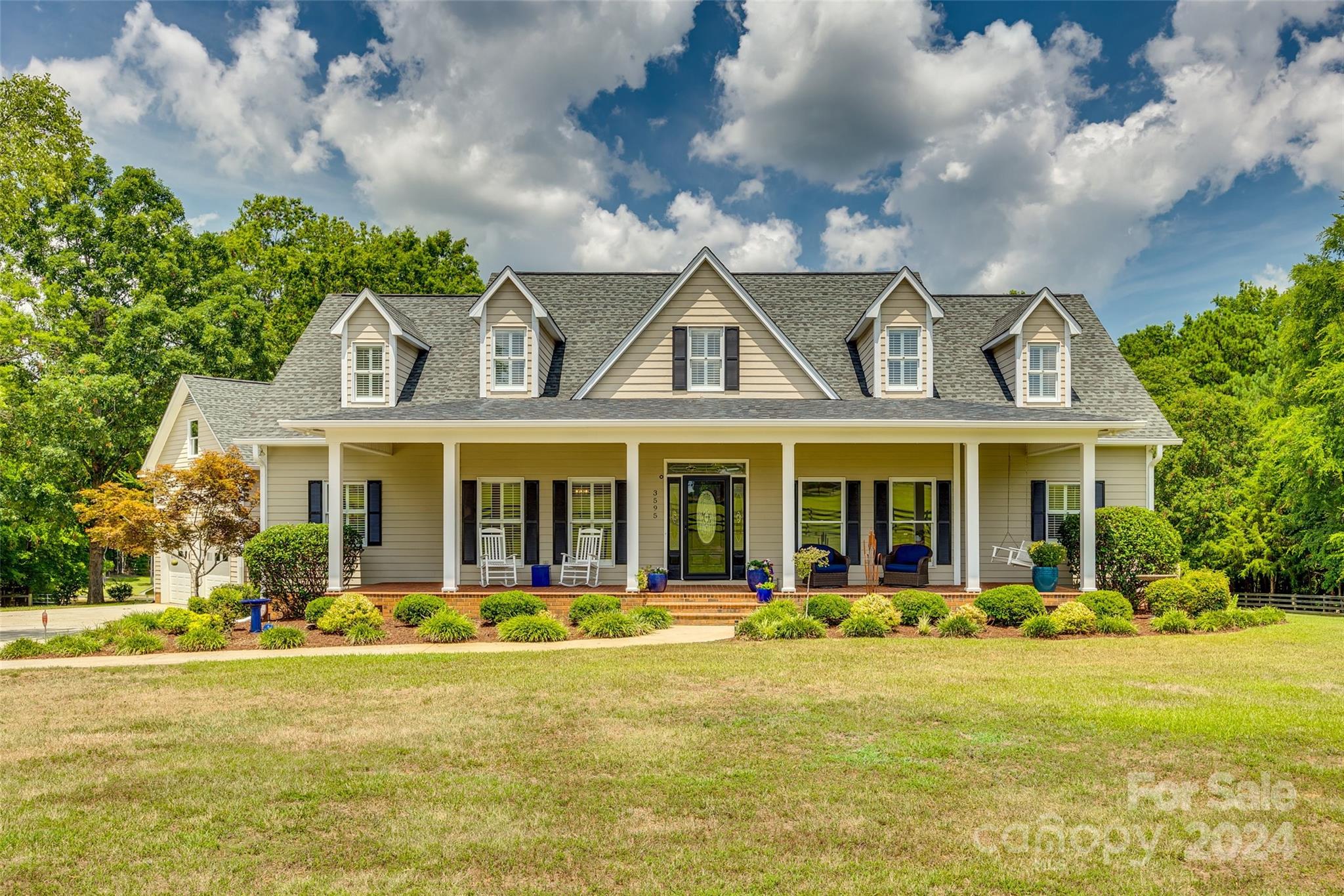 a front view of a house with swimming pool and porch