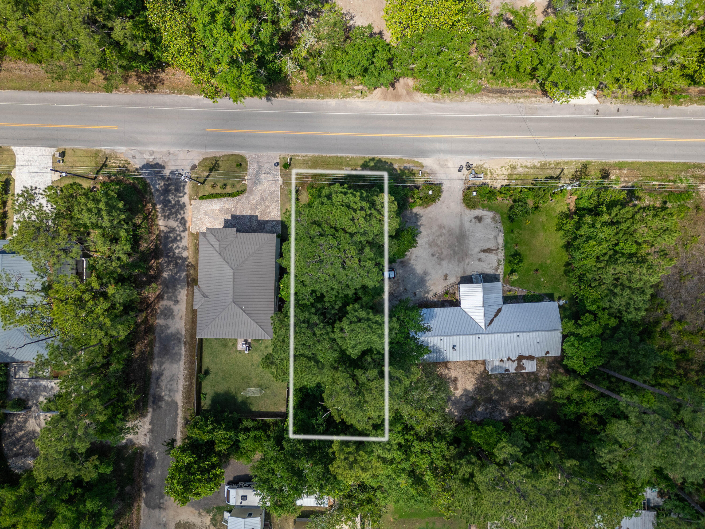 an aerial view of a house with garden space and street view