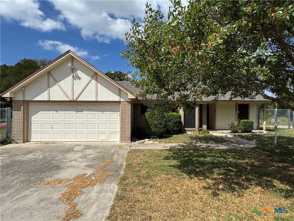 a view of a house with a yard and garage