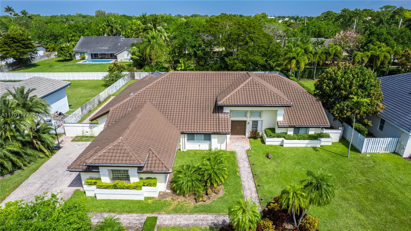 a aerial view of a house with a yard table and chairs