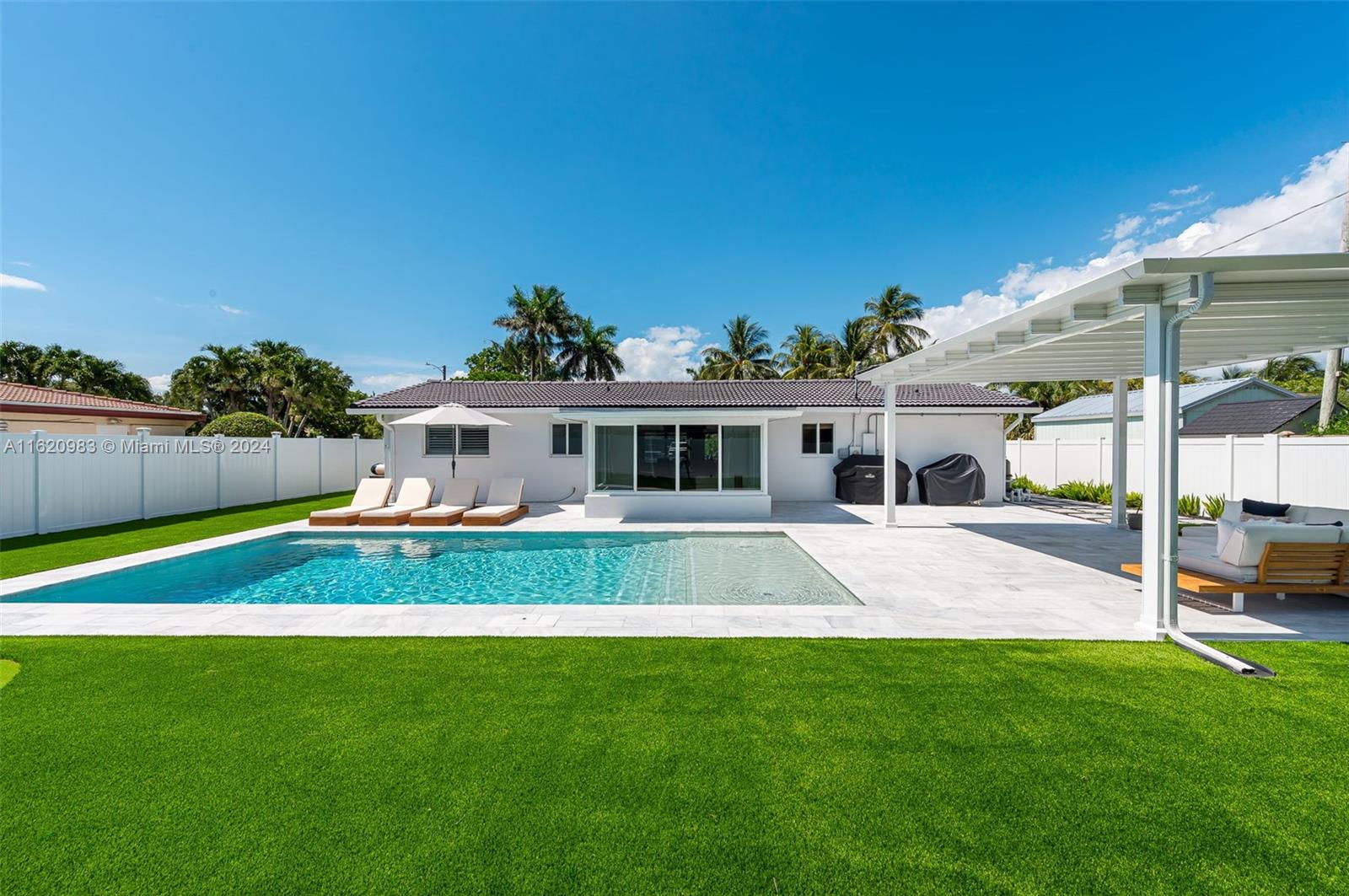 a front view of house with yard and outdoor seating