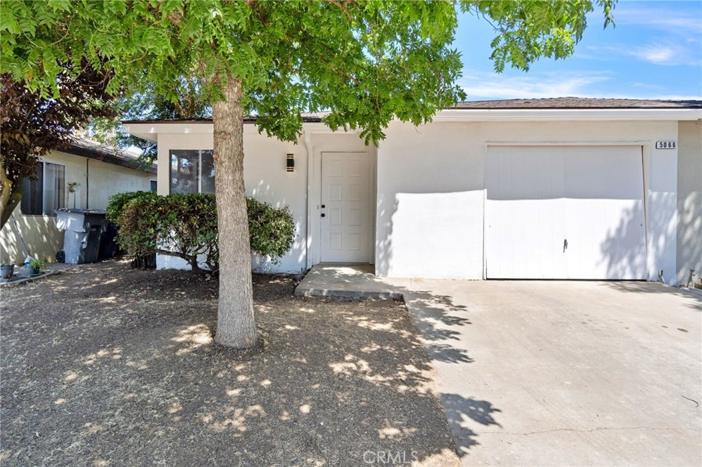 a view of a house with a yard and garage