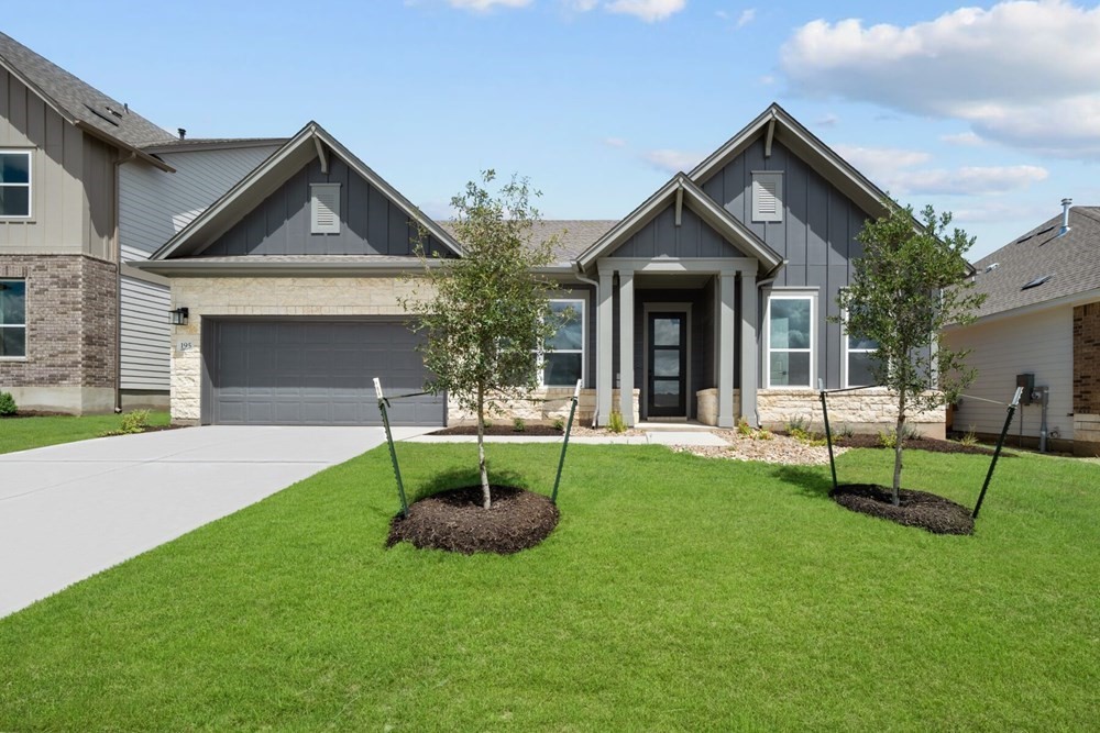 a view of an house with backyard and porch