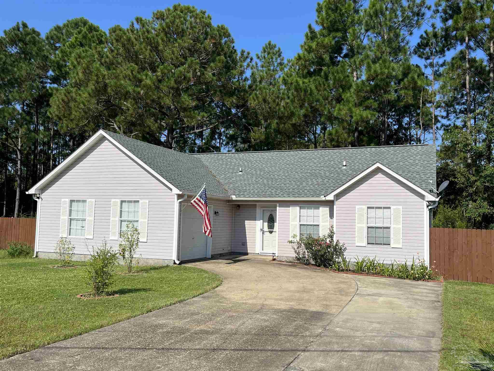 a view of front a house with a yard and garage