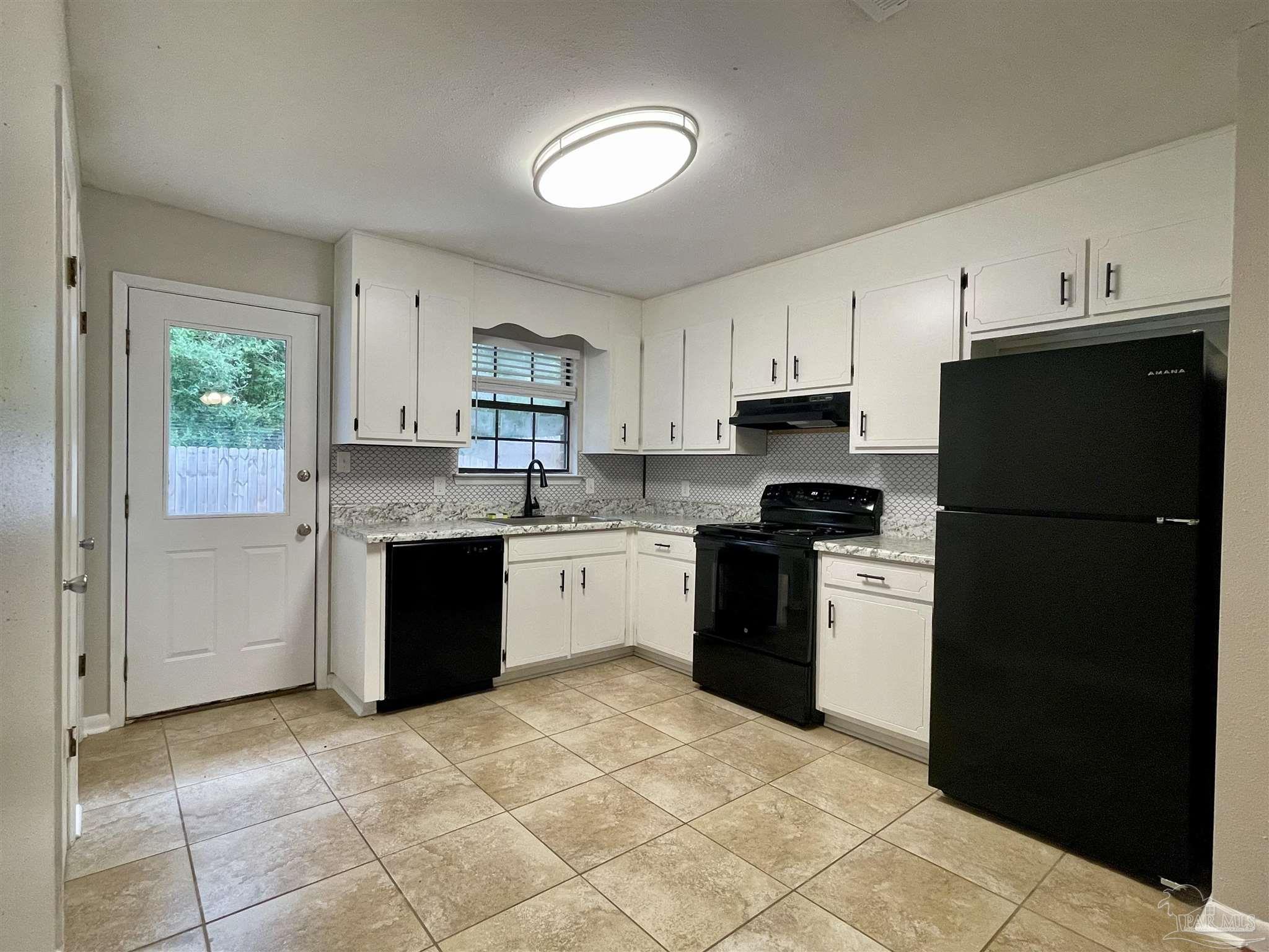 a kitchen with a refrigerator stove and sink