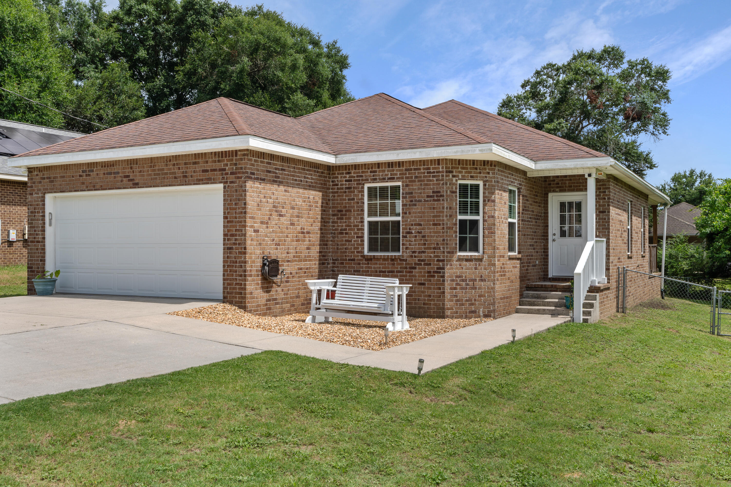 a front view of a house with a garden and patio