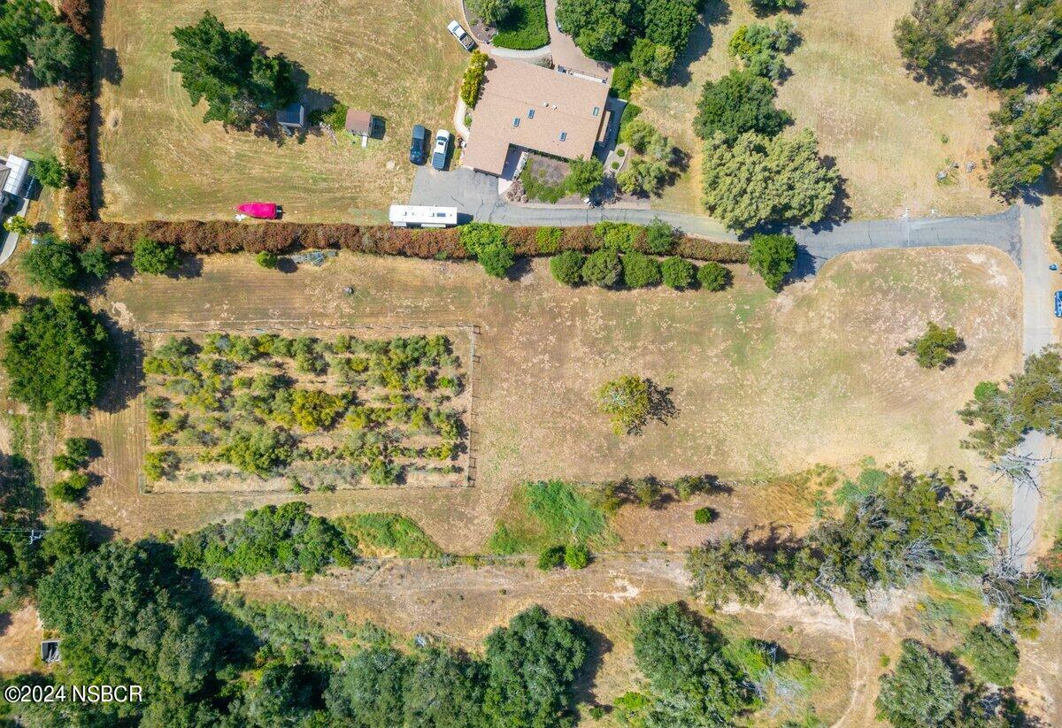 an aerial view of a building with a yard