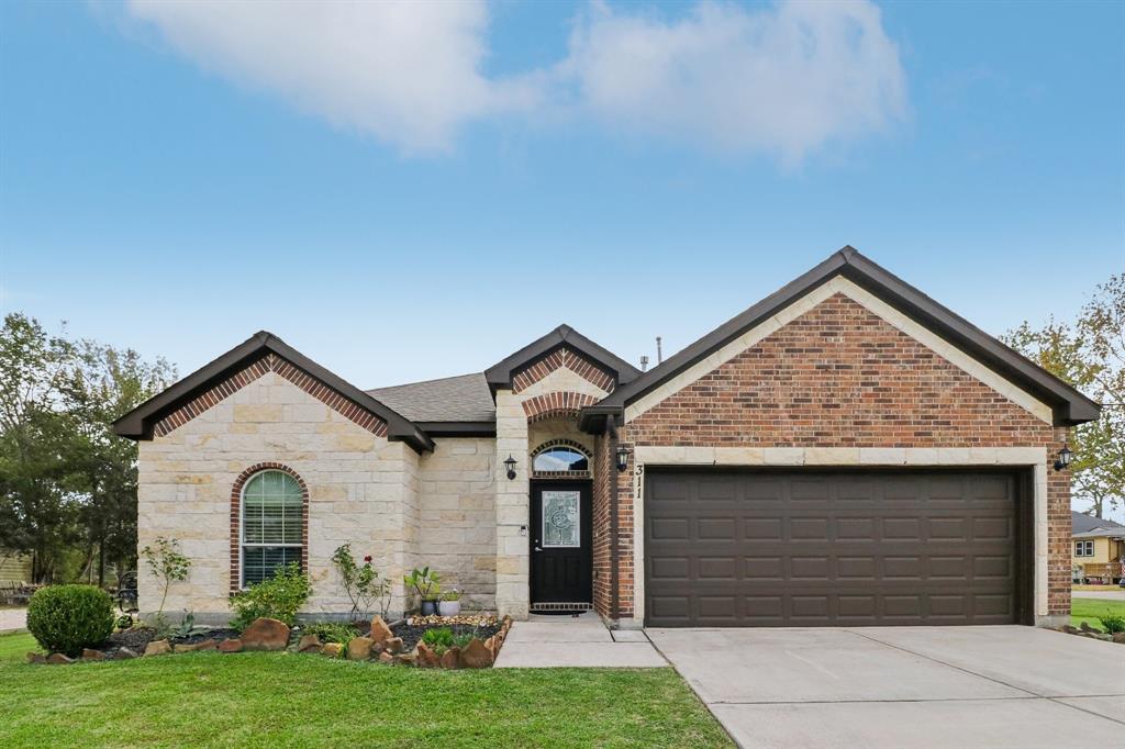 a front view of a house with a yard and garage