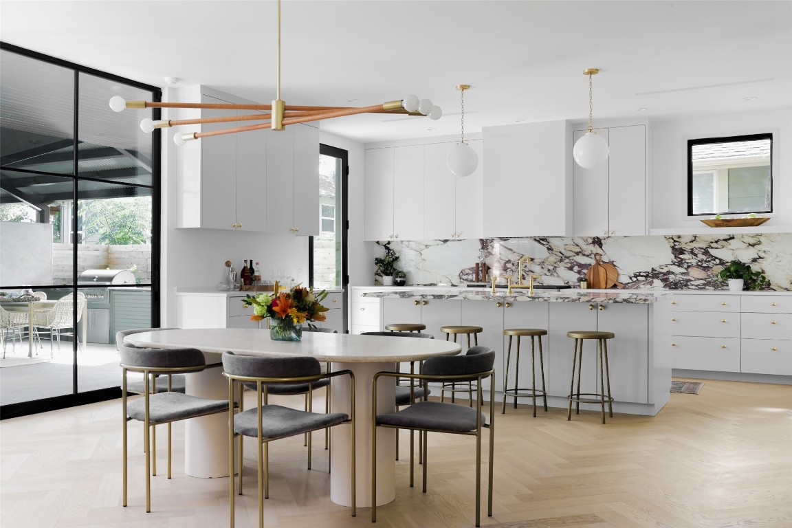 a kitchen with a table chairs stove and cabinets