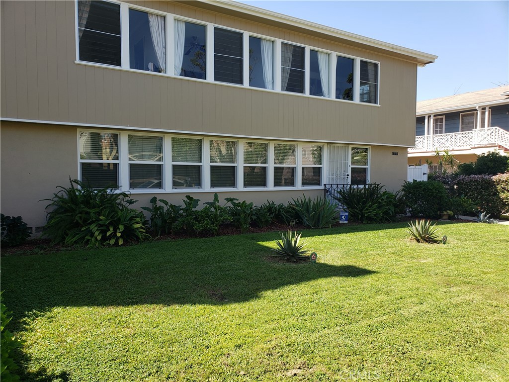 a house view with swimming pool in front of it