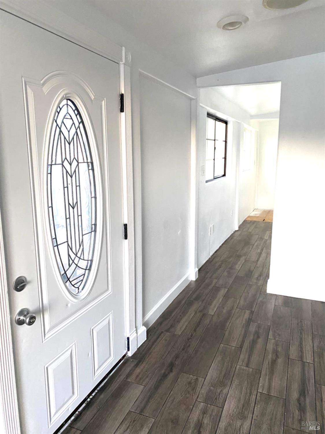 a view of a hallway with wooden floor