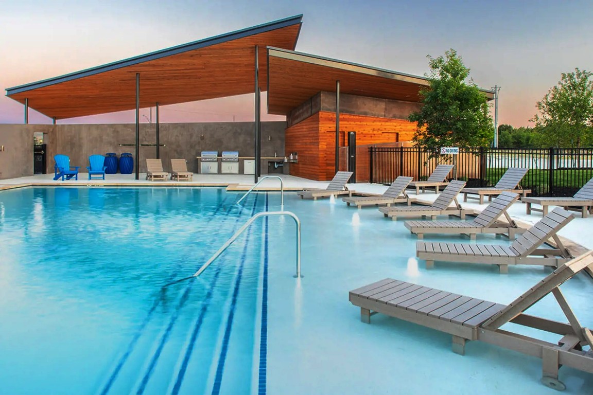 a view of a swimming pool with a lounge chair