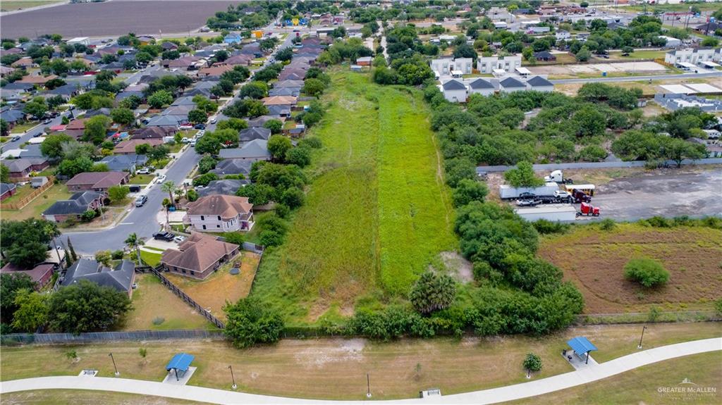 an aerial view of a house with a yard and lake view