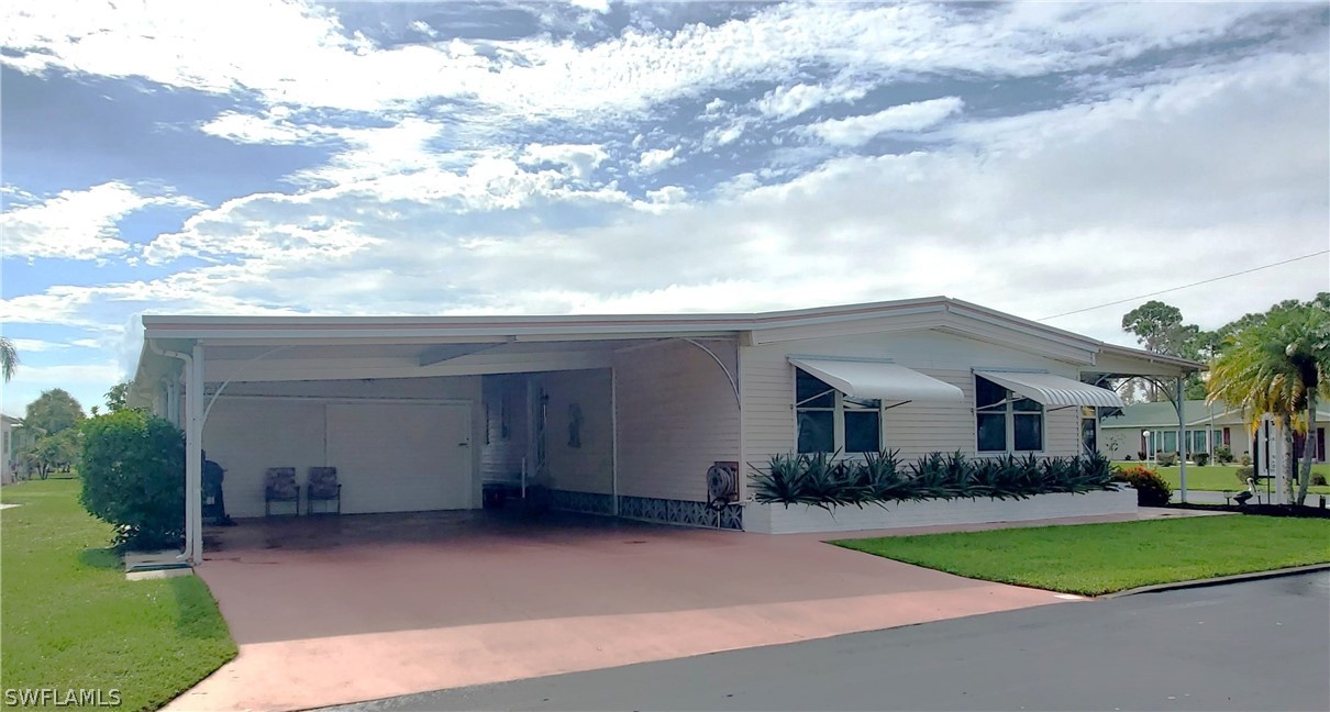 a view of house with yard and entertaining space