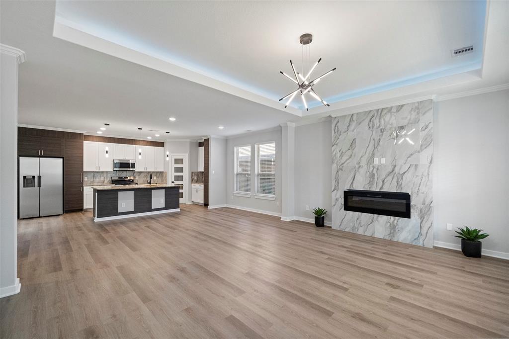 a view of empty room with wooden floor and ceiling fan